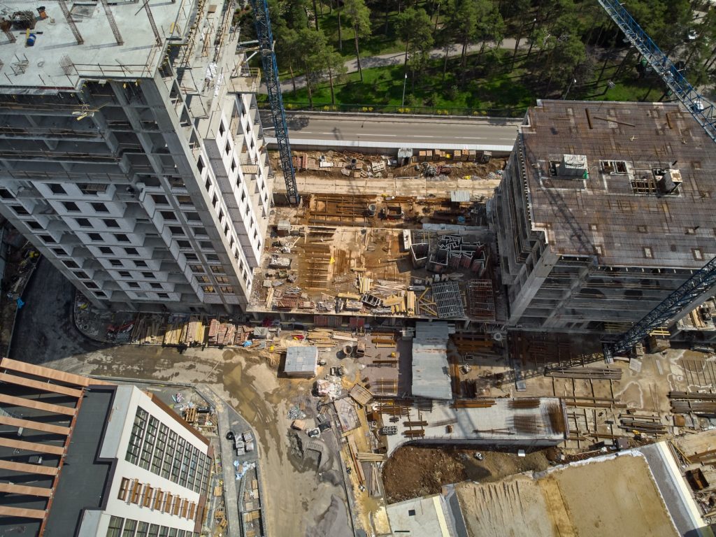 https://www.newangledrone.com/wp-content/uploads/2023/07/busy-construction-site-and-construction-equipment-aerial-photo.jpg