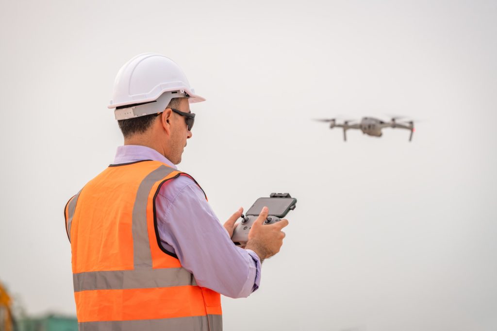 https://www.newangledrone.com/wp-content/uploads/2023/07/engineer-construction-used-drone-take-photo-aerial-view-for-inspection-and-survey-at-construction-si.jpg