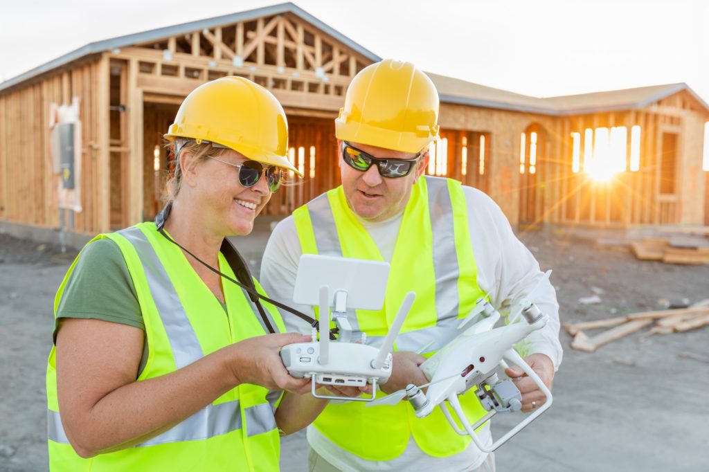 https://www.newangledrone.com/wp-content/uploads/2023/07/man-woman-construction.jpg